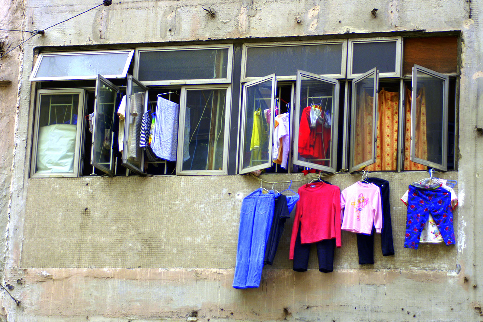 Clothing hanging from the windows of a Hong Kong home