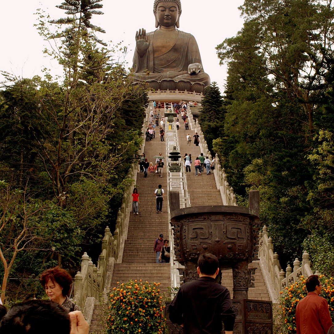 Man takes photo from bottom of stairs to Big Buddha