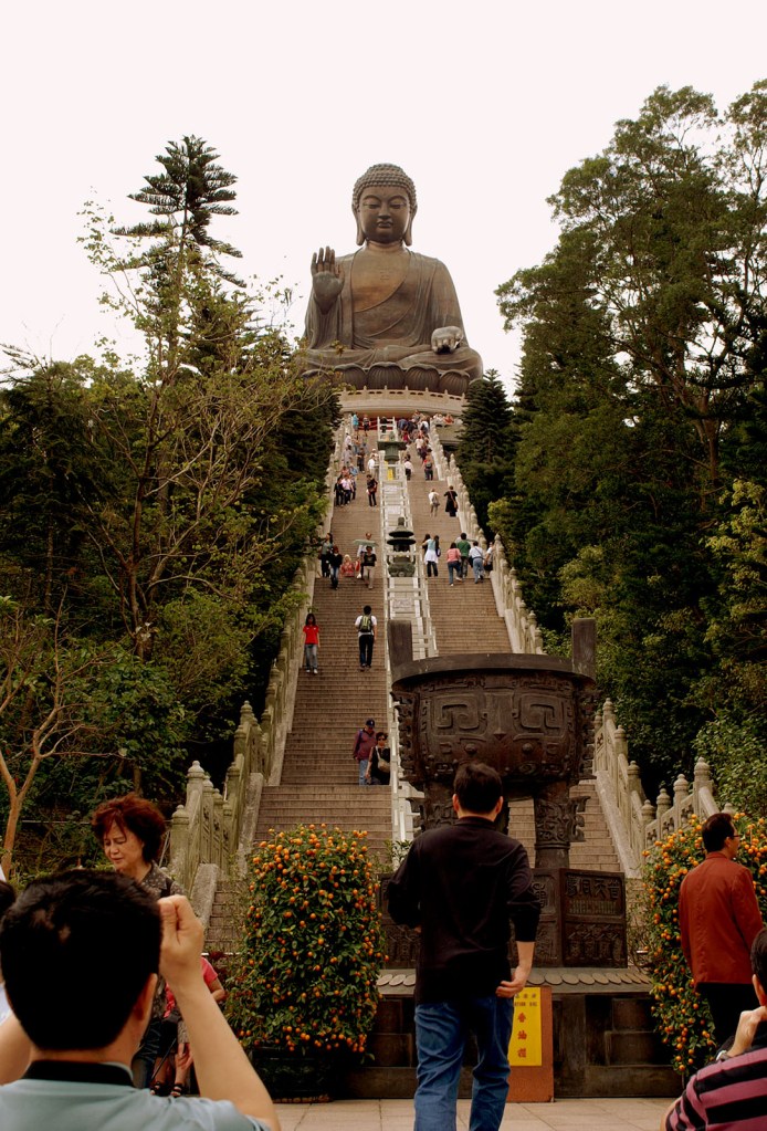 Man takes photo from bottom of stairs to Big Buddha