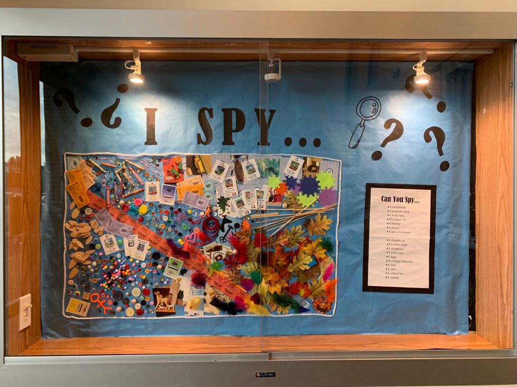 I Spy activity in wall display case for patrons to find listed items in the display